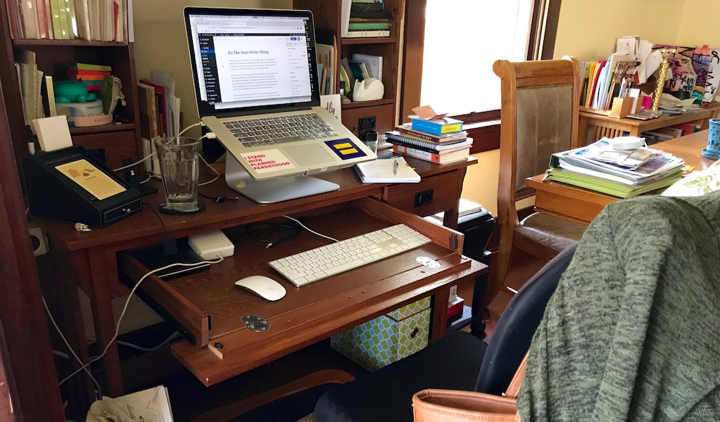 a color photo of my tiny writing desk in the corner of my dining room.